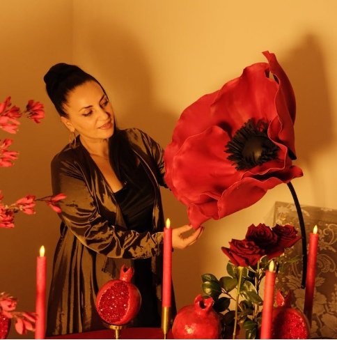 Tea presenting a handcrafted red flower installation